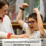 stock photo of tutor and primary child working in a library. Child is happy and punching the air. Text reads 'looking for a tutor? 30 questions to ask before hiring'