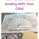 maths resources including a spinner and pictures of times tables arrays are on a table with a feelings chart that has smiley faces depicting a range of emotions and a title that reads 'how are you feeling?'