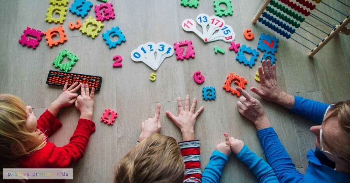 a group of children playing with maths number resources on a wooden table